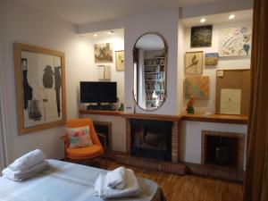 a bedroom with a bed and a mirror and a fireplace at Happy Nest in Pals Village in Pals