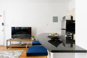 a kitchen with a black counter top and a table at 26-3B 1BR prime gramercy WD in unit Courtyard in New York