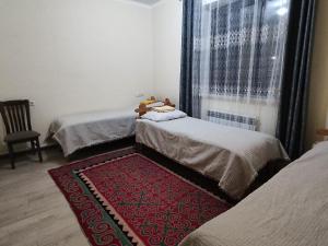 Postel nebo postele na pokoji v ubytování Tündük Guest House, Karakol