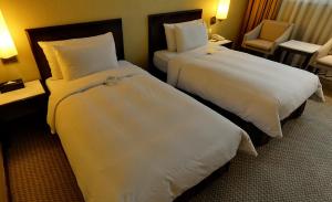 Postel nebo postele na pokoji v ubytování Taipei International Hotel