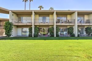 a building with a lawn in front of it at Pool and Hot Tub Access Palm Desert Studio Condo in Palm Desert