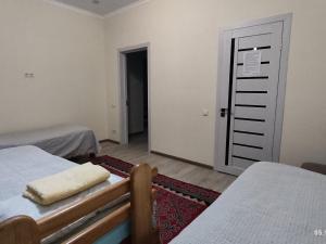 Postel nebo postele na pokoji v ubytování Tündük Guest House, Karakol