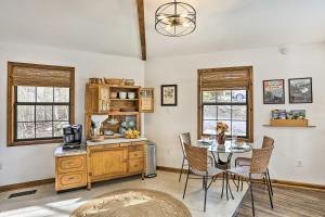 a dining room with a table and a kitchen at Picturesque Cottage in the Heart of Trenton! in Trenton