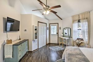 a bedroom with a bed and a ceiling fan at Picturesque Cottage in the Heart of Trenton! in Trenton
