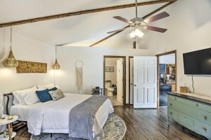 a bedroom with a bed and a ceiling fan at Picturesque Cottage in the Heart of Trenton! in Trenton