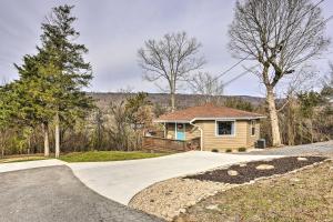 a home with a driveway leading to a house at Picturesque Cottage in the Heart of Trenton! in Trenton