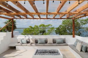 a living room with a couch and a table at Casa Marivan, Private Pier, Free Paddle Boards & Kayac in Bacalar