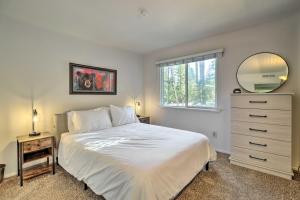 a bedroom with a white bed and a mirror at Tahoe City Home with Hot Tub - 1 Mi to Beach in Tahoe City