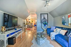 a living room with a blue couch and a tv at Eclectic Chicago Apartment with Spacious Deck! in Chicago