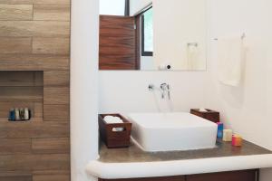 a bathroom with a white sink and a mirror at Casa Marivan, Private Pier, Free Paddle Boards & Kayac in Bacalar +18 photos