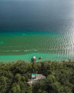 an aerial view of a beach with a boat in the water at Casa Marivan, Private Pier, Free Paddle Boards & Kayac in Bacalar