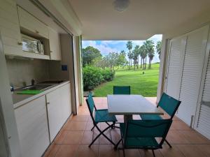 a kitchen with a table and chairs on a patio at Studio village vacances sainte luce C6 in Sainte-Luce