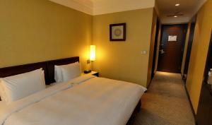 Postel nebo postele na pokoji v ubytování Taipei International Hotel