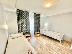 a small room with two beds and a window at Hotel 7F in Kyiv