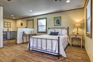 a bedroom with a bed and a kitchen at Cozy Fredericksburg Studio Near Wineries! in Fredericksburg