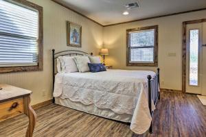a bedroom with a bed and two windows at Cozy Fredericksburg Studio Near Wineries! in Fredericksburg