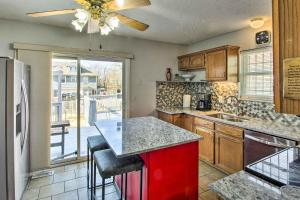 a kitchen with a red island and a large window at Central Kansas City Home Less Than 3 Mi to Downtown! in Kansas City