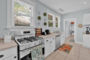 a kitchen with a stove top oven in a room at Cheerful Midtown home with view of Rhodes College in Memphis