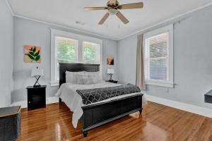 a bedroom with a bed and a ceiling fan at Cheerful Midtown home with view of Rhodes College in Memphis
