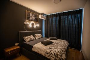 a bedroom with a bed and a window at HERMES APARTMENT & 2 free secured parkings in Ljubljana