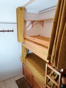 a cupboard in a tiny house with a staircase at Studio Montagne à la Pierre St Martin in Arette