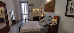 a bedroom with a bed and a table and chairs at Classy central apartment in Bari