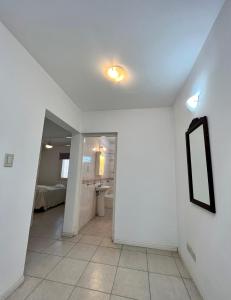 a hallway with a mirror on the wall and a bathroom at Duplex Céntrico TaLau in San Juan +7 photos