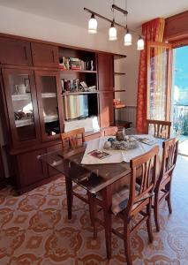 a dining room with a wooden table and chairs at La Beccaccia in Baceno