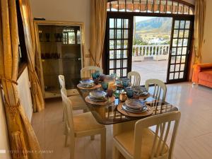 a dining room with a table and chairs with a view at Villa Sally in Adeje