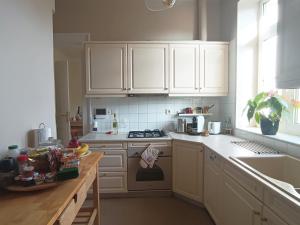 a kitchen with white cabinets and a stove top oven at AcroView in Athens