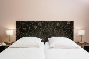 Postel nebo postele na pokoji v ubytování Hotel Aigner