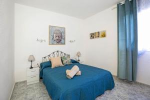 a bedroom with a bed with a blue blanket at Apartamento Poris in Arico +27 photos