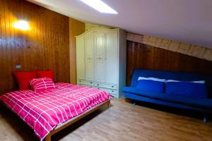 - une chambre avec un lit et un canapé bleu dans l'établissement Molise da scoprire e da sciare, à San Massimo
