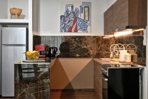 a kitchen with a refrigerator and a counter top at Stylish Apartment, Acropolis view in Athens