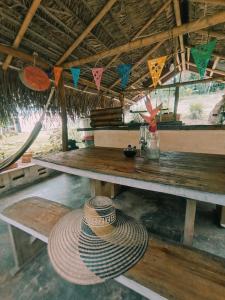 a straw hat sitting on a table in a hut at La Casa en el Aire in Palomino