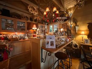 a kitchen with a counter and a bar in it at Anerada inn Suites & Villa - Pet Friendly in Karpenision