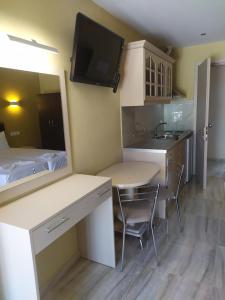 a small kitchen with a table and a sink at SMILE in Platamonas