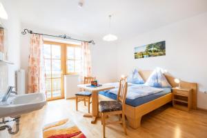 a room with a couch and a table and a sink at Appartement Achenhof in Bad Hofgastein