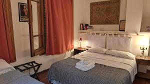 a bedroom with a bed with towels on it at Boutique Hotel Casa Rugantino in Buenos Aires