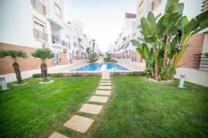 a courtyard with a swimming pool in a building at Dream Holidays Cabanas in Tavira