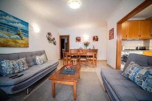a living room with a couch and a table at Dream Holidays Cabanas in Tavira