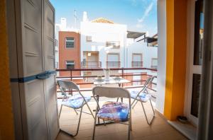 a balcony with chairs and a table on a balcony at Dream Holidays Cabanas in Tavira
