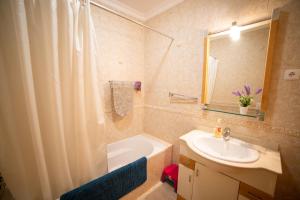 a bathroom with a tub and a sink and a shower at Dream Holidays Cabanas in Tavira +12 photos