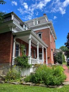 a large red brick house with white columns at The Big Brickhouse in Mercer