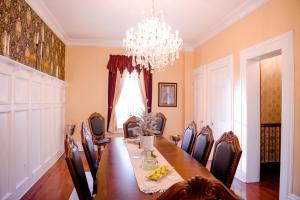 a dining room with a long table and a chandelier at The Big Brickhouse in Mercer