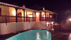 a swimming pool in front of a house at night at Villa les Angélines in Dubois