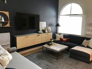 a living room with a couch and a tv at Quiet, convenient & Modern Haven in Gainesville
