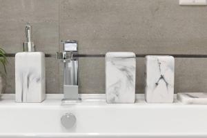 a group of four bottles on a bathroom counter at 78-1B New 1BR prime UES WD in unit BEST VALUE in New York