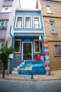 a blue building with a store on a street at Ortakoy Aysem Sultan Hotel in Istanbul