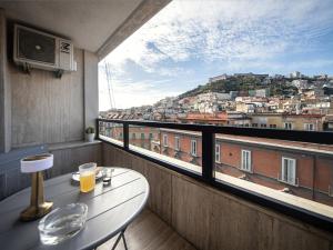a balcony with a table and a view of a city at Salotto Borbonico in Naples